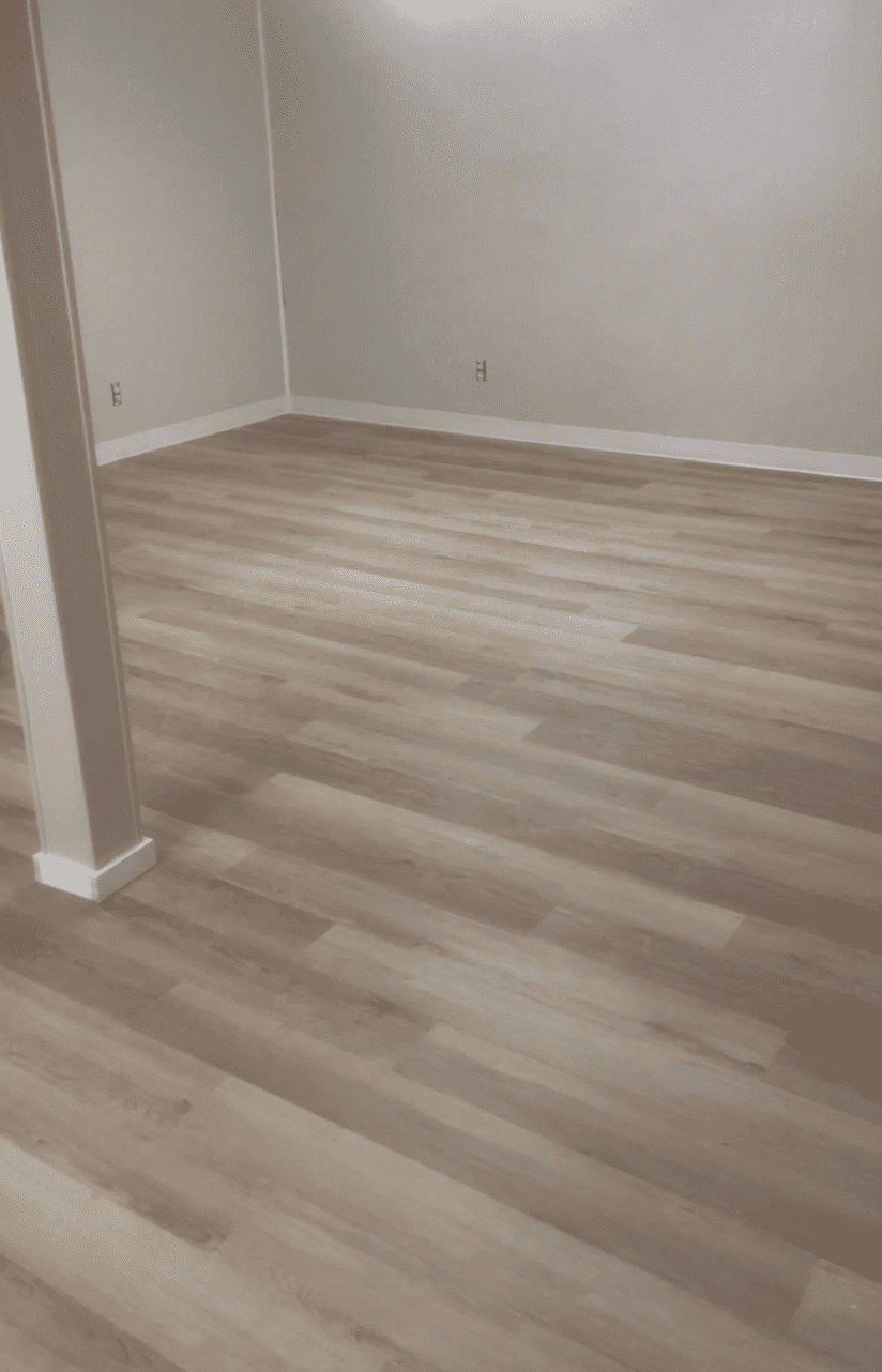 New plank flooring with fresh baseboard and base shoe trim