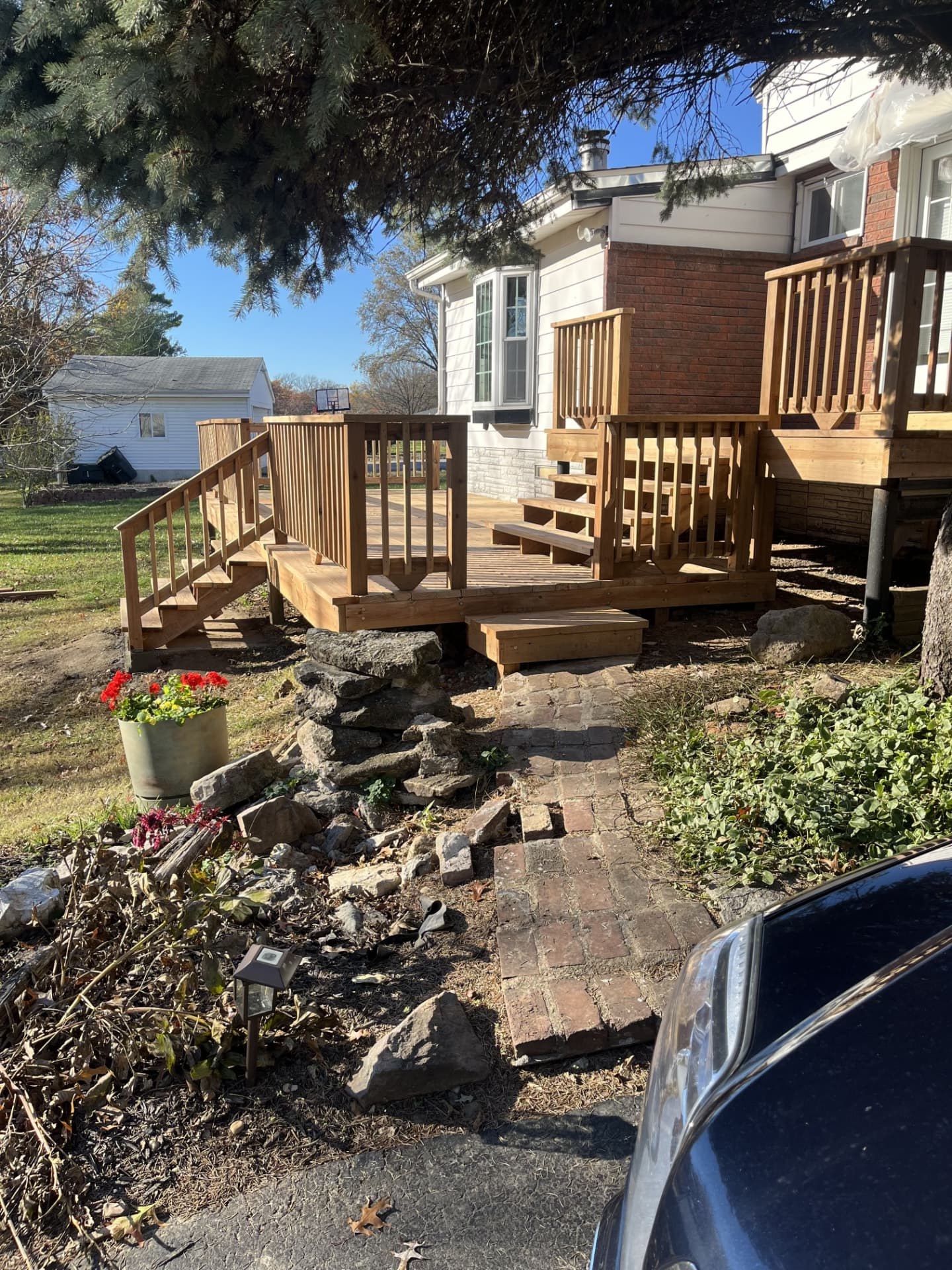 Finished deck with railing sections, benches and steps to the walkway
