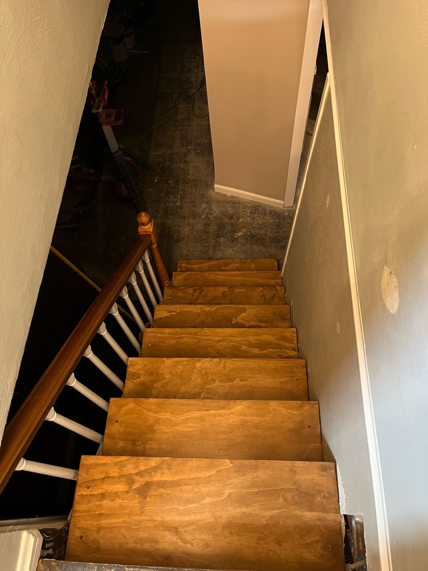 Basement staircase rebuilt with new stained treads and handrail