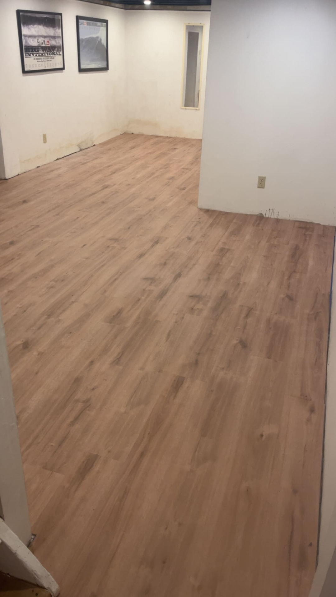 Luxury vinyl plank flooring installed in a finished lower level
