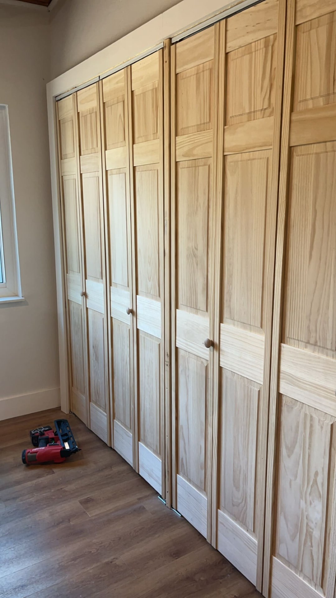 Solid pine bi-fold closet doors with new casing and trim installed