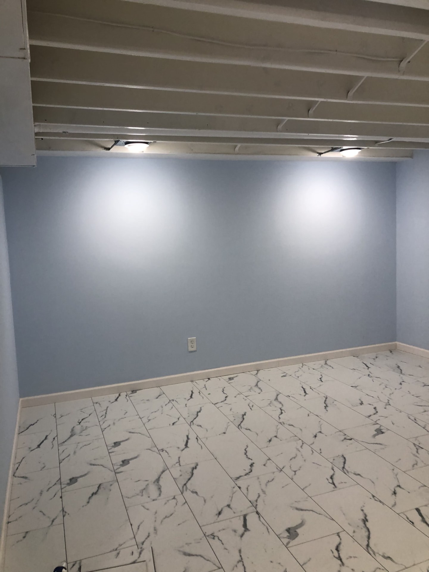 Remodeled room with new tile floor, base trim and painted walls