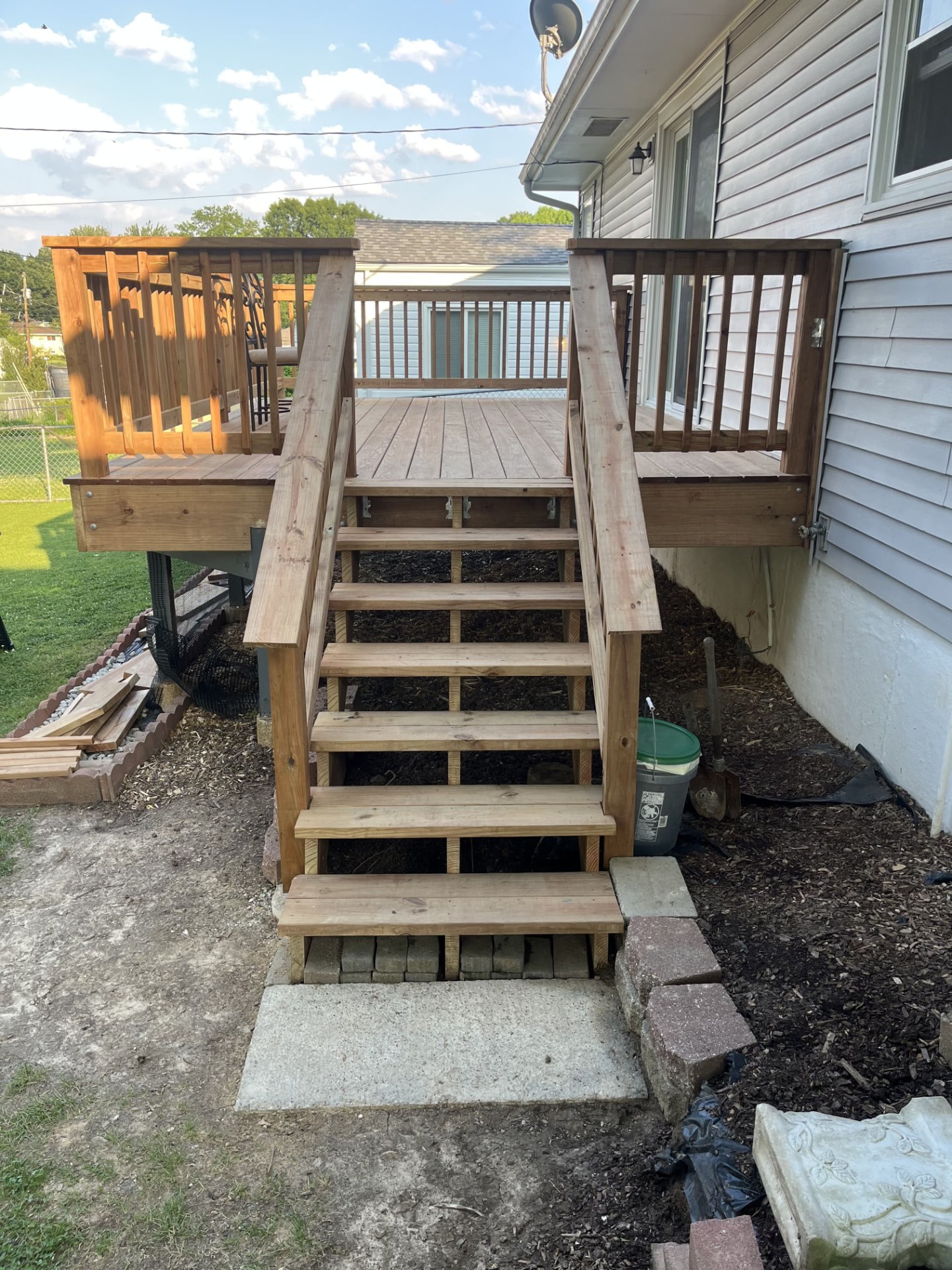 New deck stairs framed at a covered rear entry