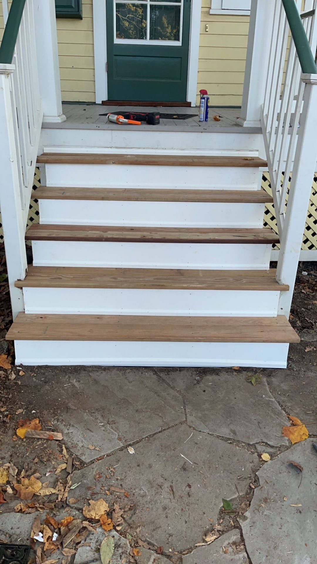 Rebuilt porch steps with wood treads and crisp white risers