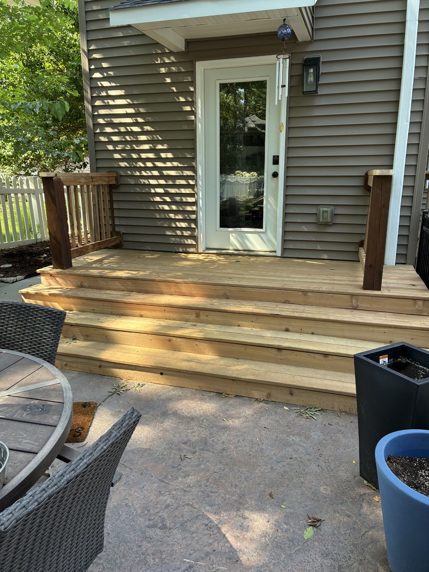 Wood deck platform and steps built over a stone patio