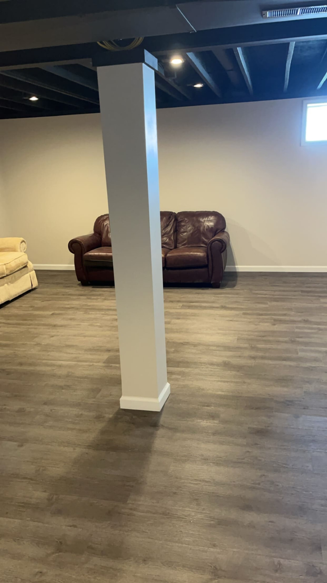 Finished basement with new vinyl plank flooring and base shoe