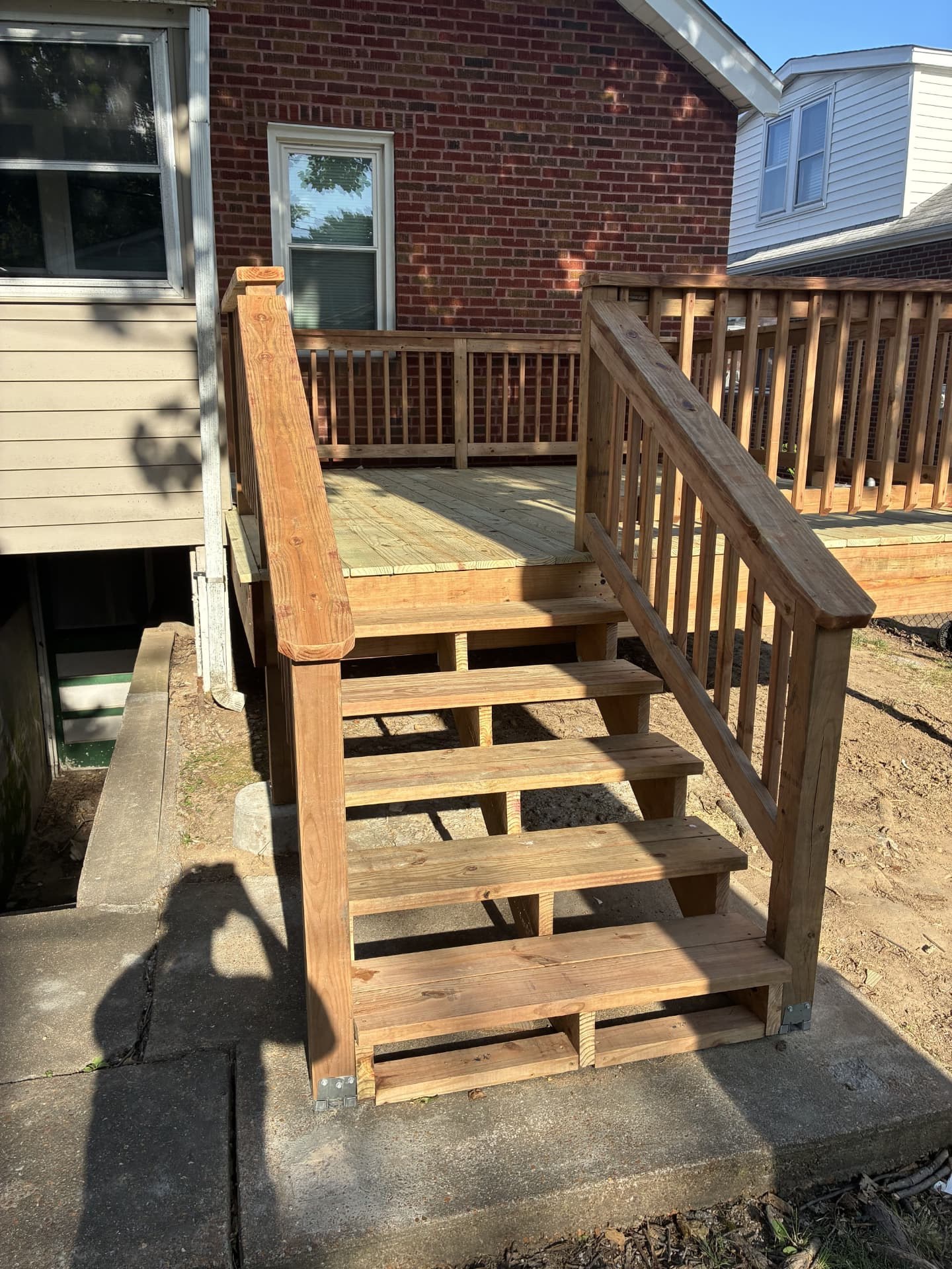 Framed deck landing and stair stringers at a brick home in St. Louis