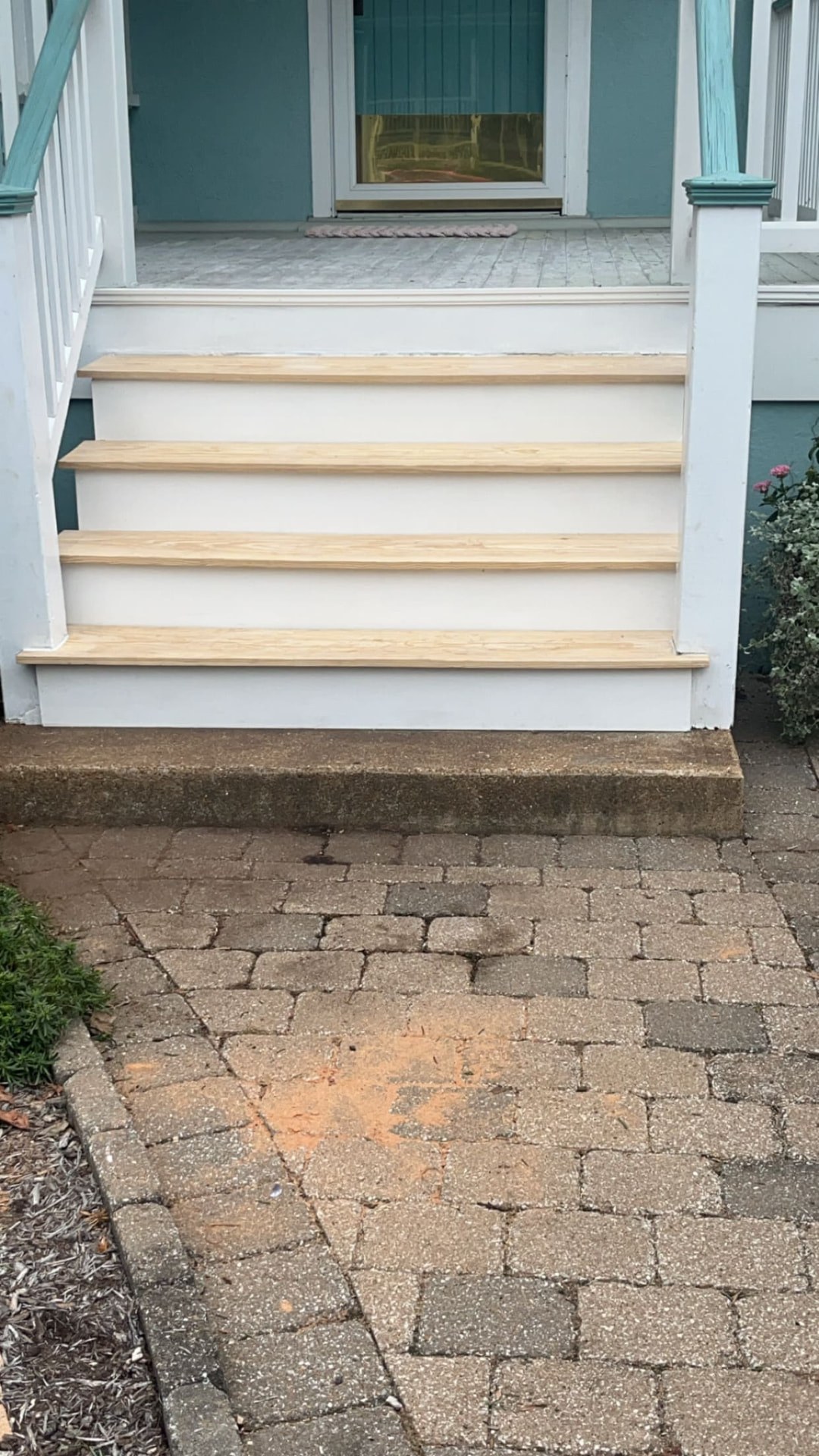 New pine treads installed on a covered front porch staircase